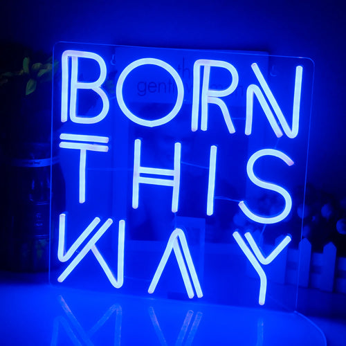 En livlig LED-neonskylt som visar frasen "Born This Way" i kursiv skrift.