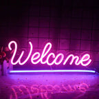 A vibrant "Welcome" LED neon sign displayed against a plain white wall.