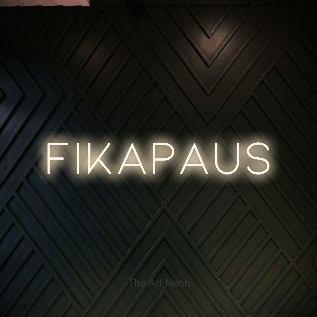LED neon sign reading “FIKAPAUS”, arranged in a single line.