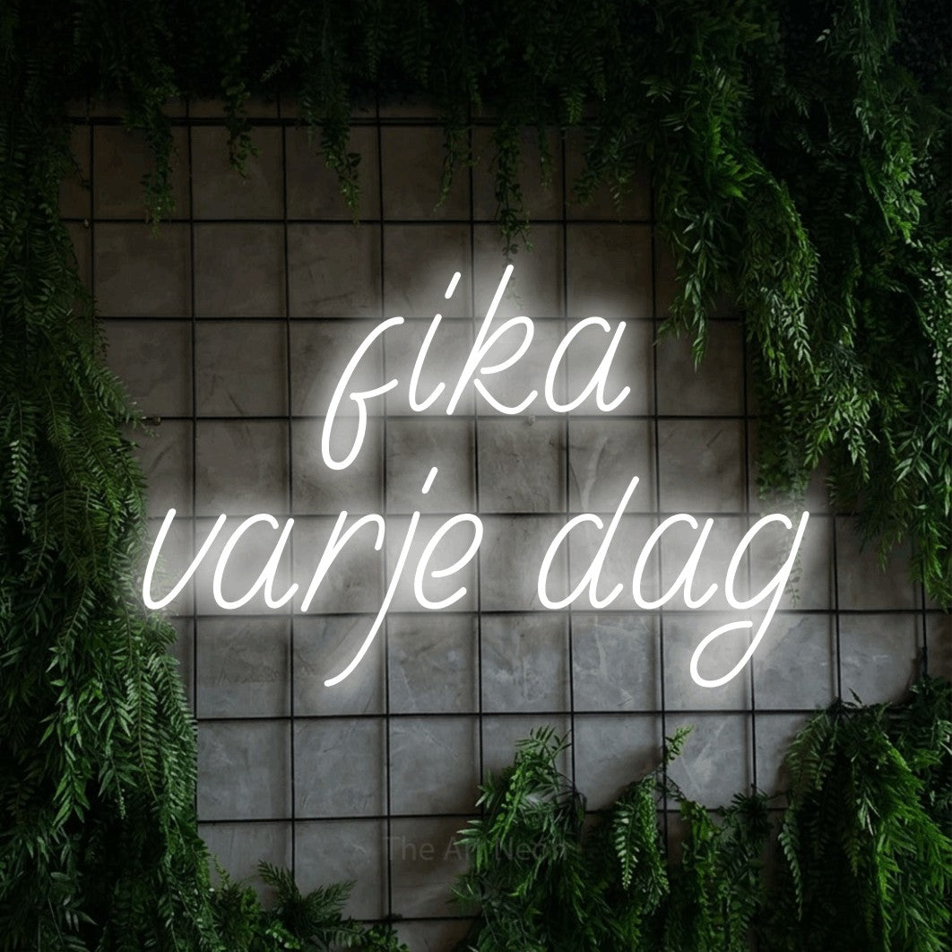 LED neon sign reading “fika varje dag”, arranged in 2 lines.
