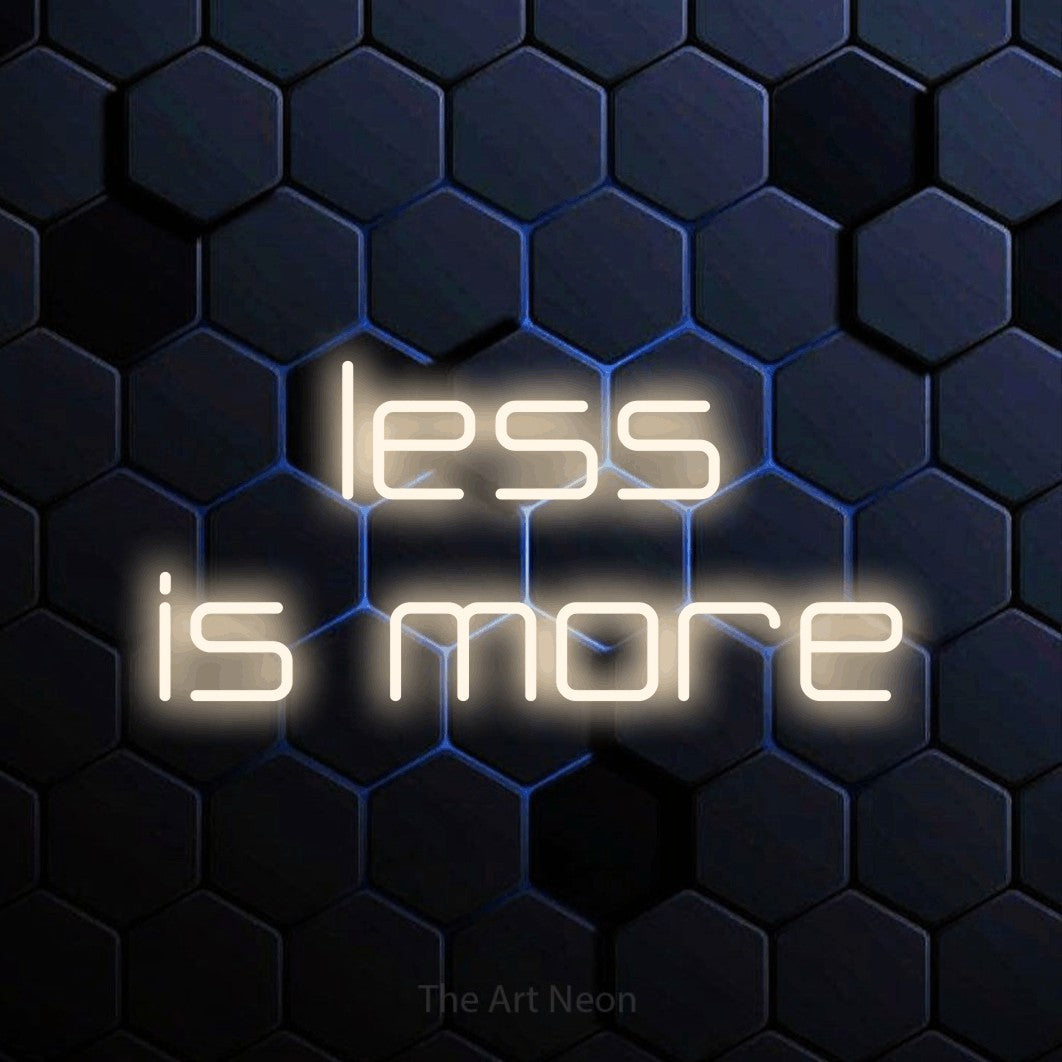 LED neon sign reading “less is more”, arranged in 2 lines.