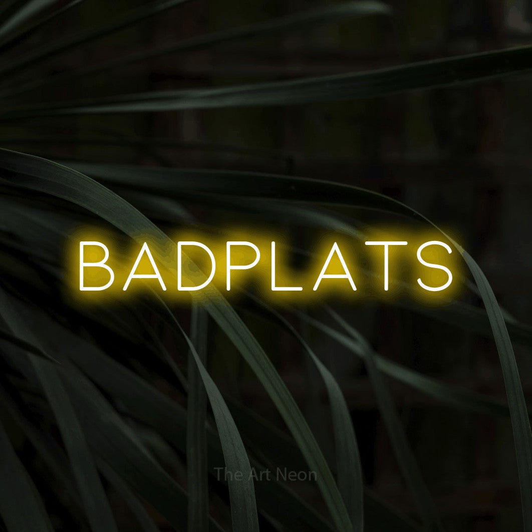 LED neon sign reading “badplats”, arranged in a single line.
