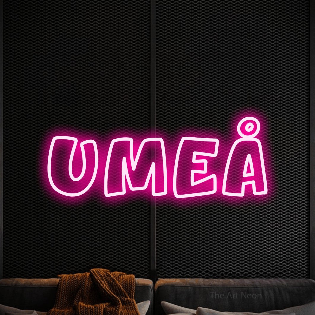 LED neon sign reading “UMEÅ”, arranged in a single line.