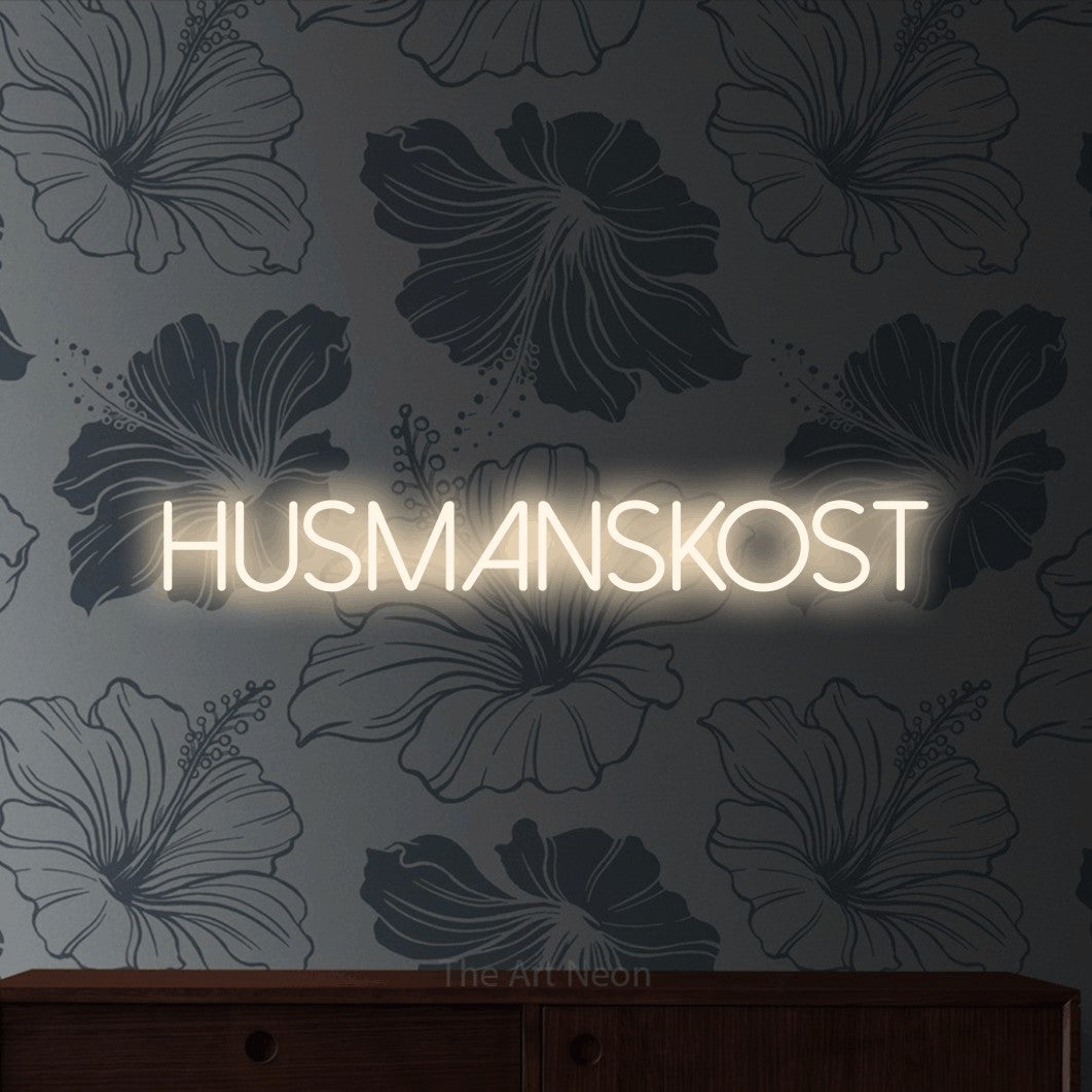LED neon sign reading “Husmanskost”, arranged in a single line.