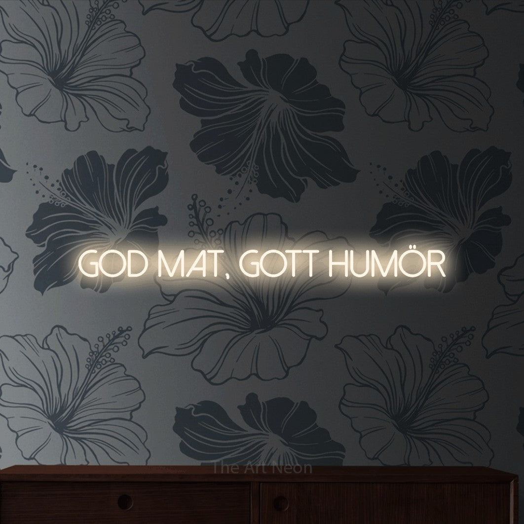 LED neon sign reading “god mat, gott humör”, arranged in a single line.