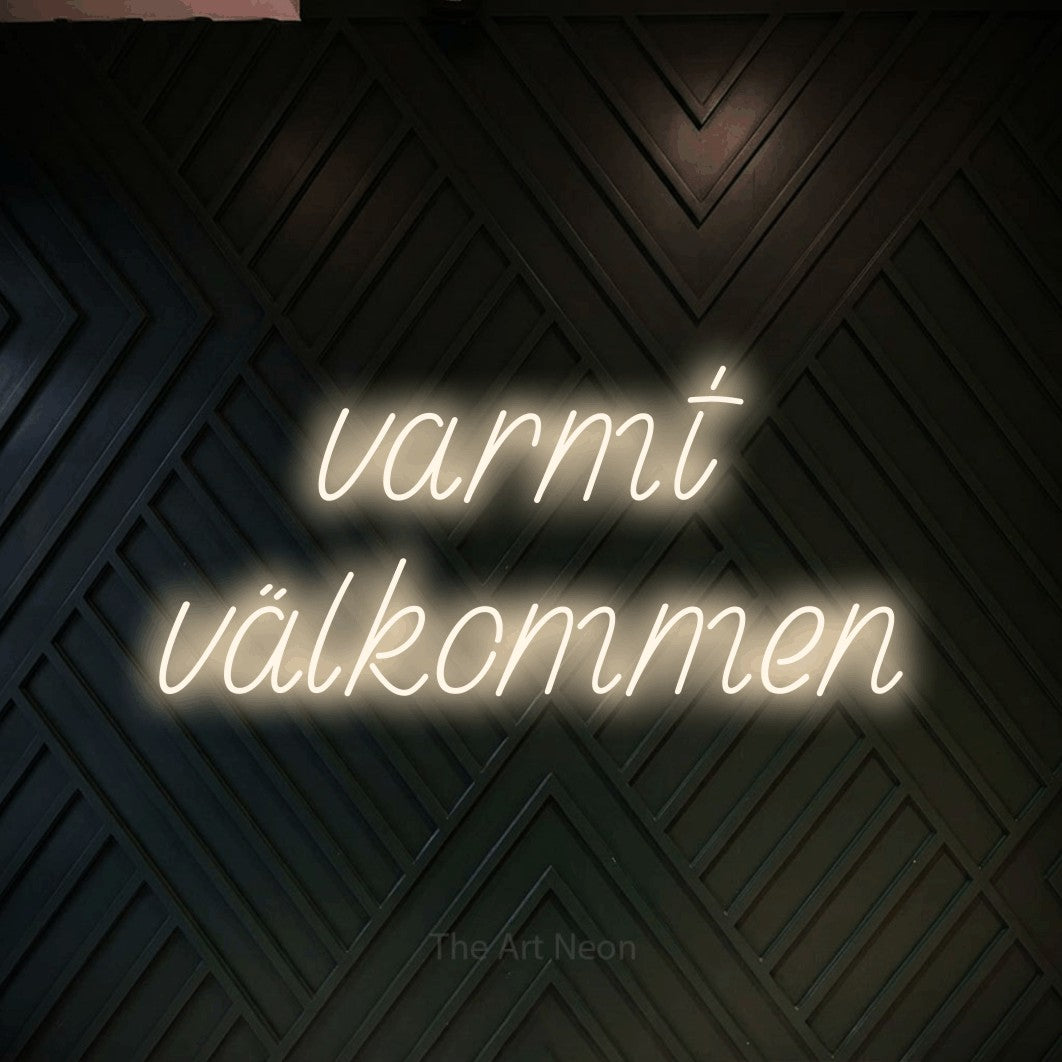 LED neon sign reading “varmt välkommen”, arranged in 2 lines.