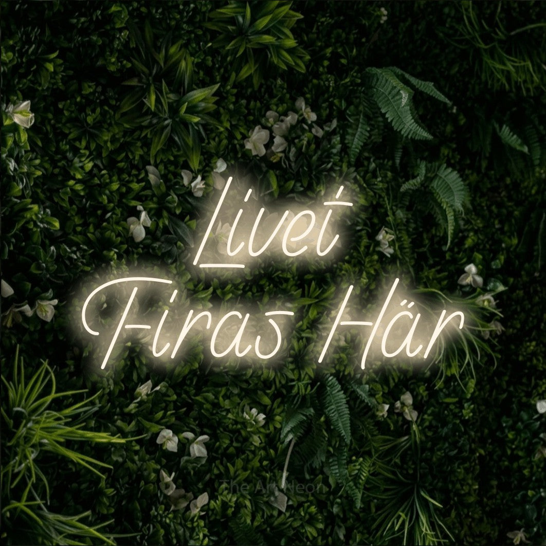 LED neon sign reading “Livet Firas Här”, arranged in 2 lines.