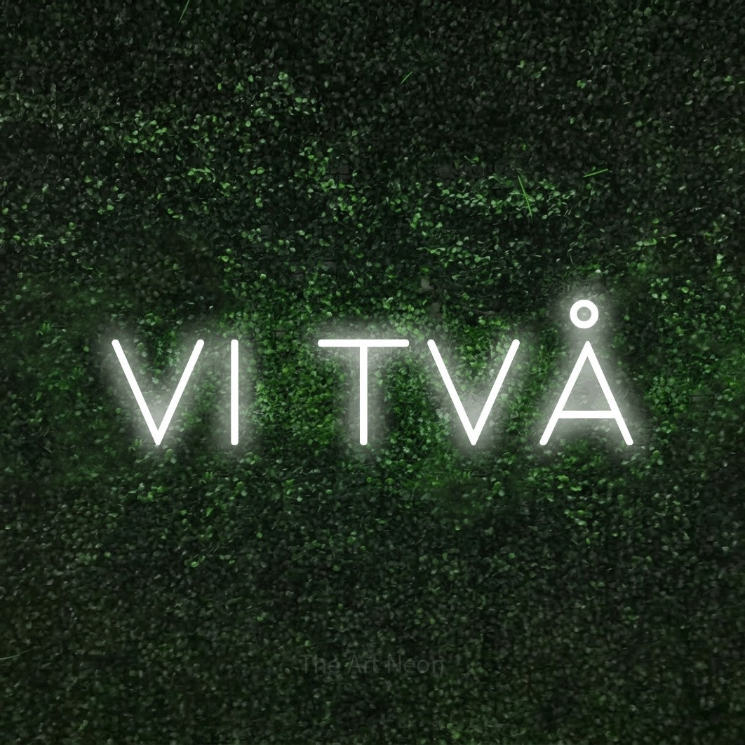 LED neon sign reading “vi två”, arranged in a single line.