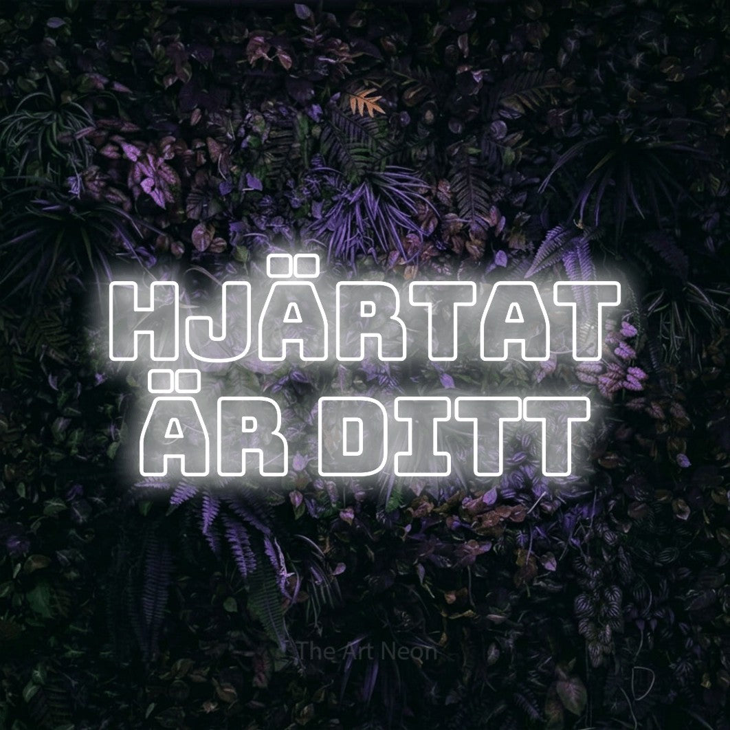 LED neon sign reading “Hjärtat Är Ditt”, arranged in 2 lines.