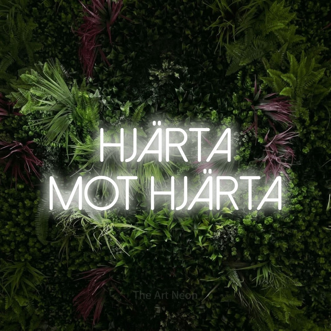 LED neon sign reading “hjärta mot hjärta”, arranged in 2 lines.