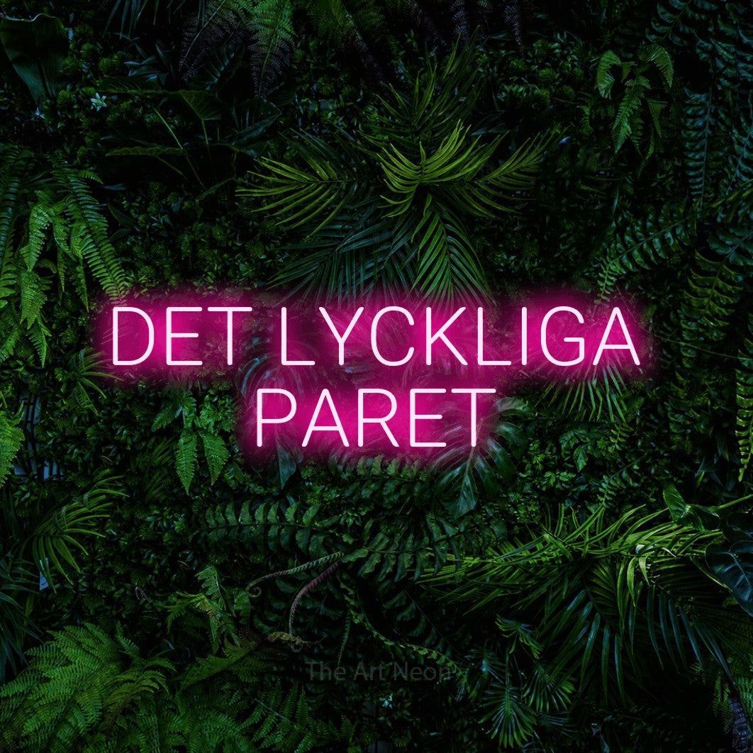 LED neon sign reading “DET LYCKLIGA PARET”, arranged in 2 lines.