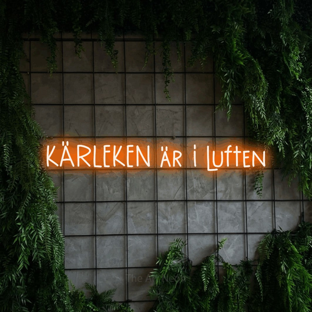 LED neon sign reading “KÄRLEKEN är i luften”, arranged in a single line.