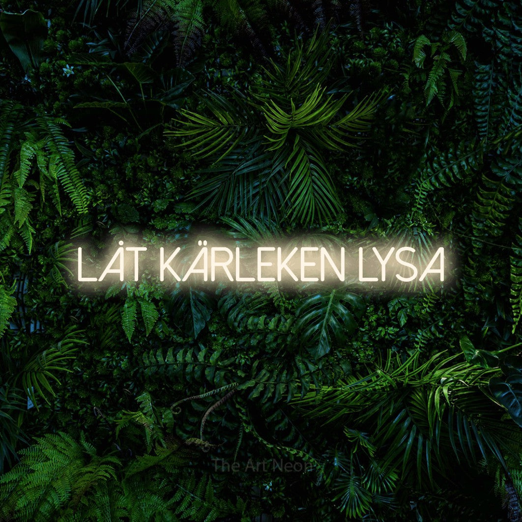 LED neon sign reading “låt KÄRLEKEN lysa”, arranged in a single line.