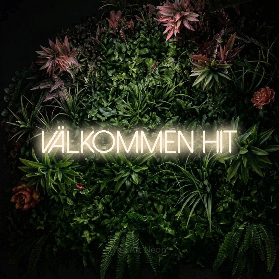 LED neon sign reading “VÄLKOMMEN HIT”, arranged in a single line.