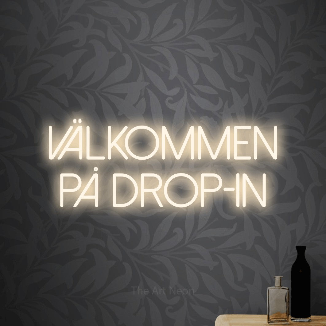 LED neon sign reading “Välkommen På Drop-in”, arranged in 2 lines.