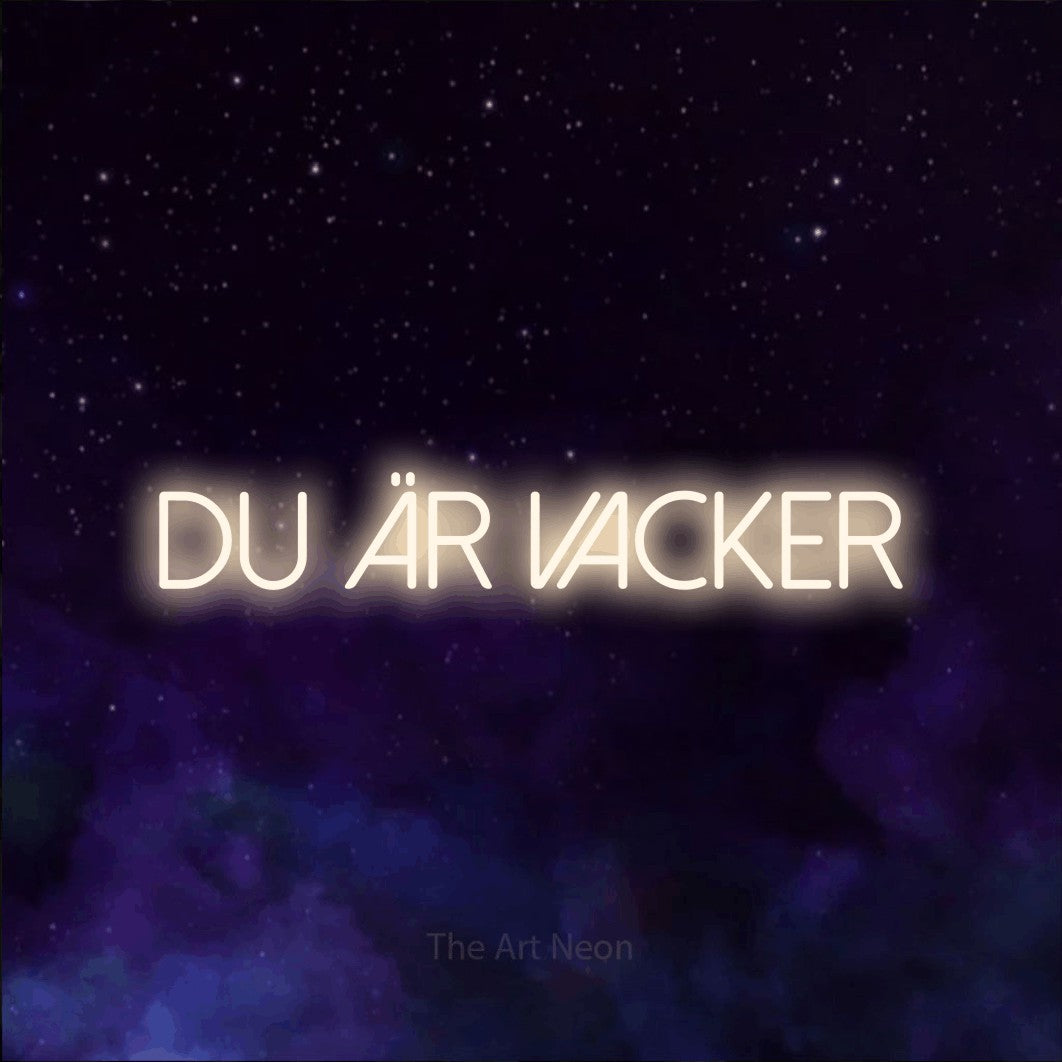 LED neon sign reading “DU ÄR VACKER”, arranged in a single line.
