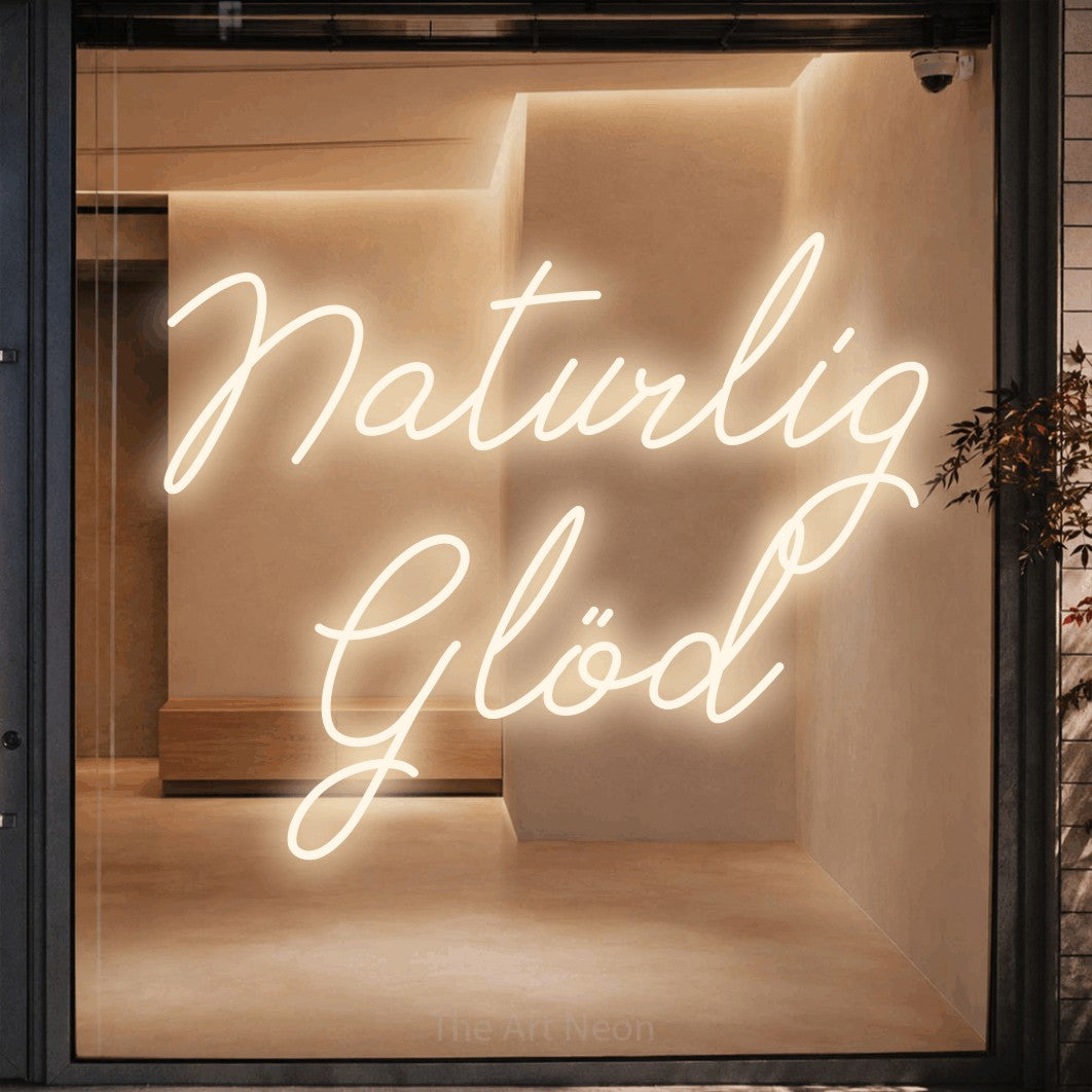 LED neon sign reading “Naturlig Glöd”, arranged in 2 lines.