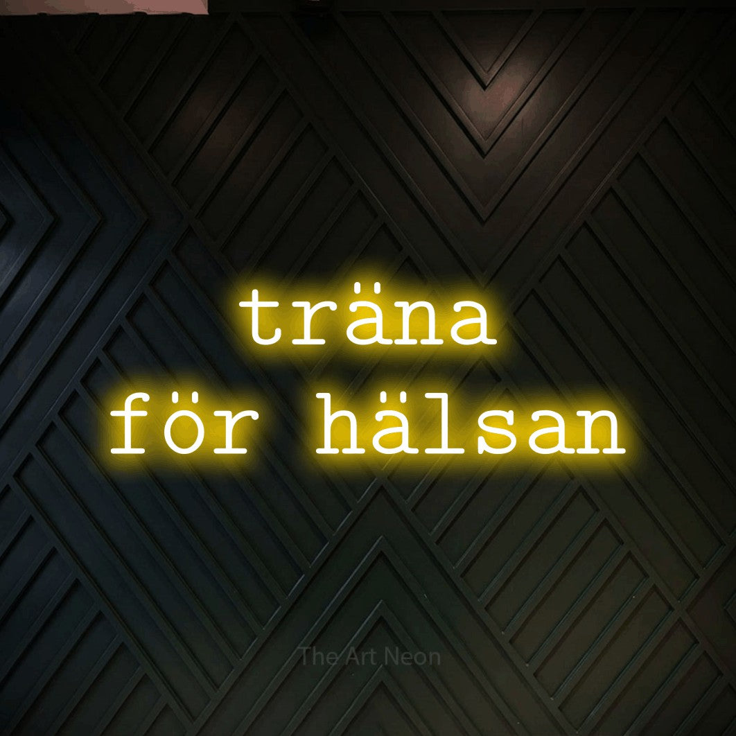 LED neon sign reading “träna för hälsan”, arranged in 2 lines.