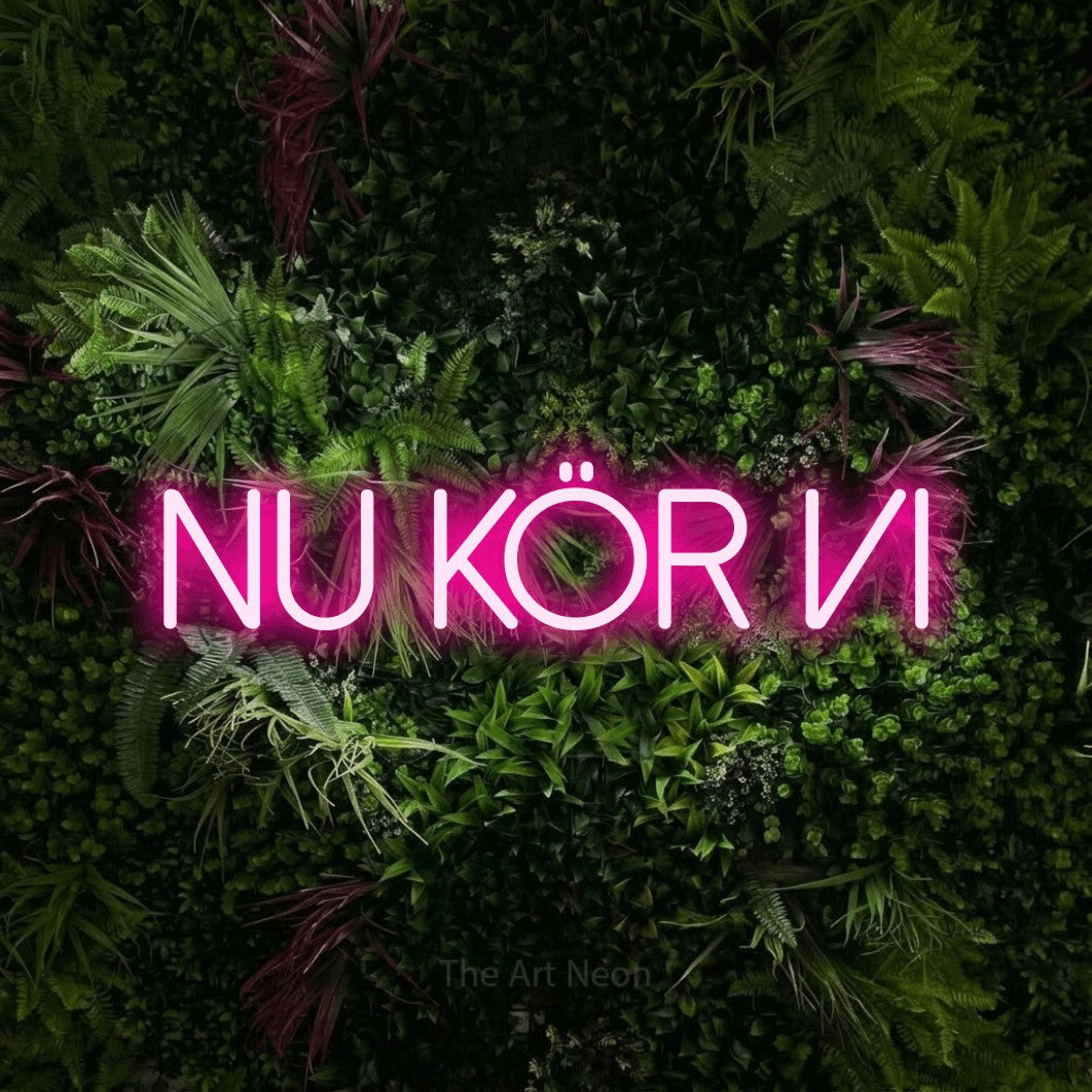 LED neon sign reading “Nu Kör Vi”, arranged in a single line.