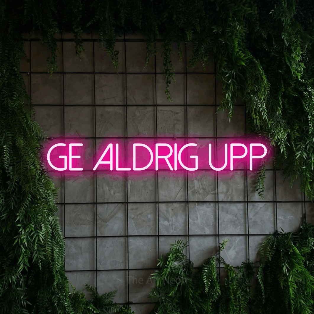 LED neon sign reading “ge aldrig upp”, arranged in a single line.