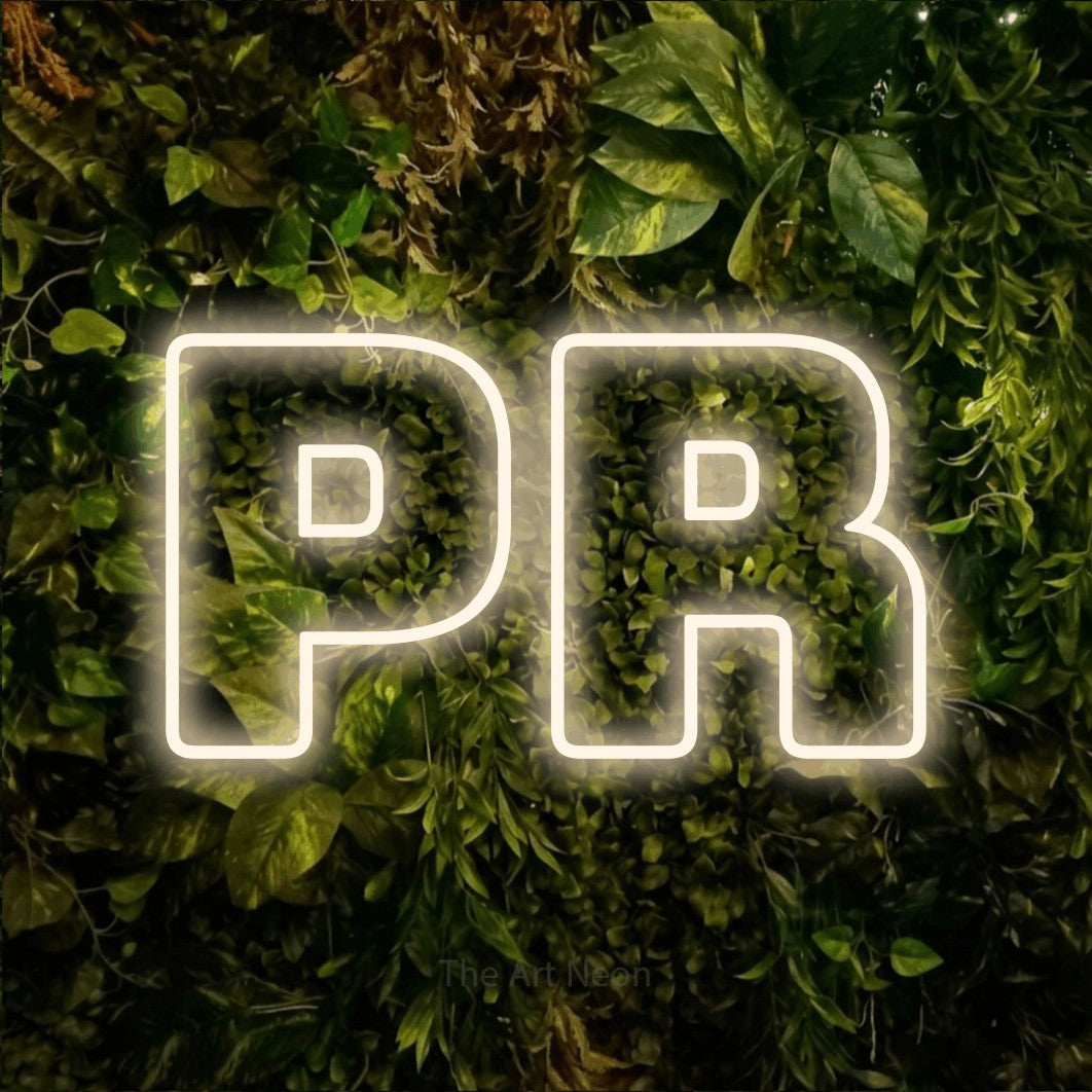LED neon sign reading “PR”, arranged in a single line.