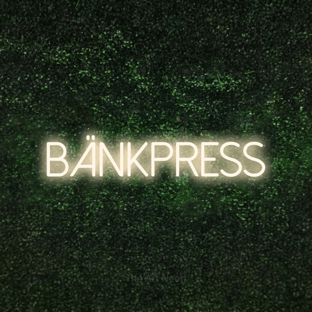 LED neon sign reading “BÄNKPRESS”, arranged in a single line.