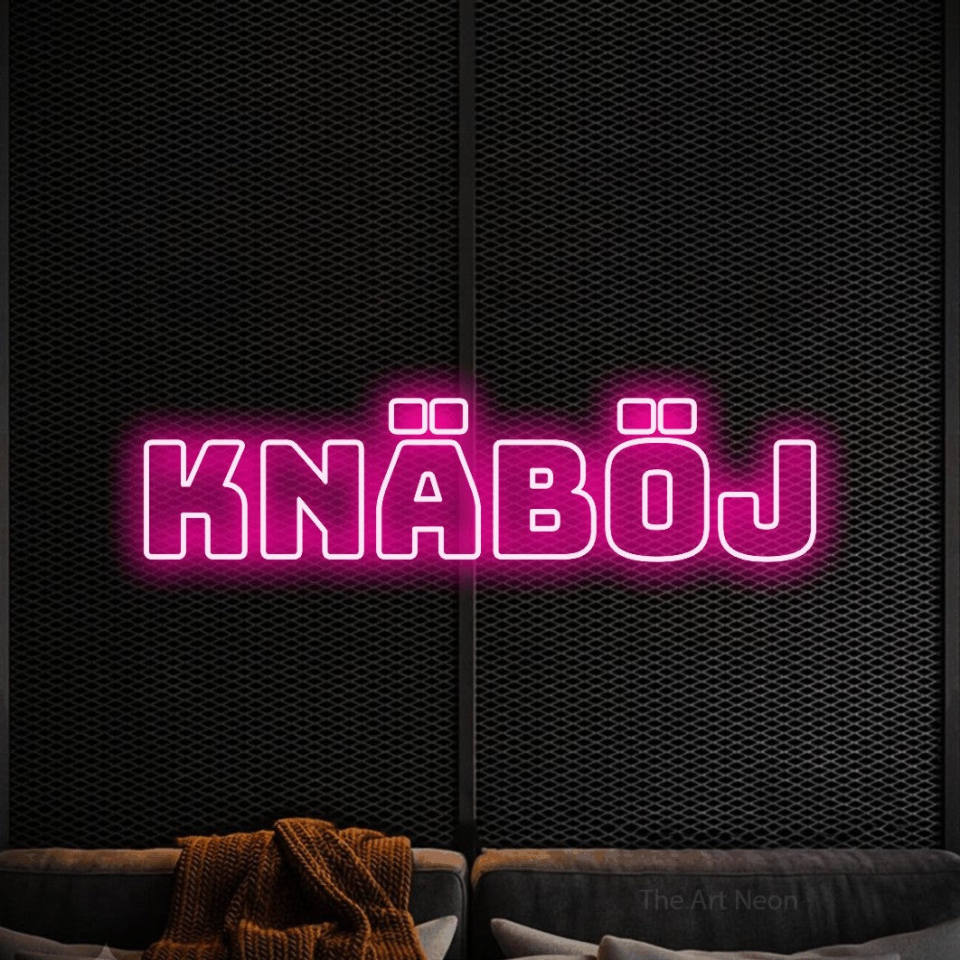LED neon sign reading “KNÄBÖJ”, arranged in a single line.