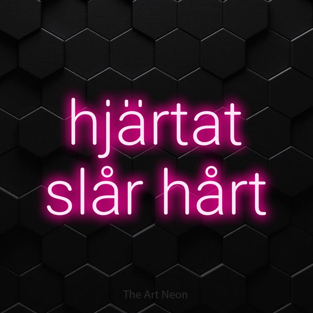 LED neon sign reading “hjärtat slår hårt”, arranged in 2 lines.