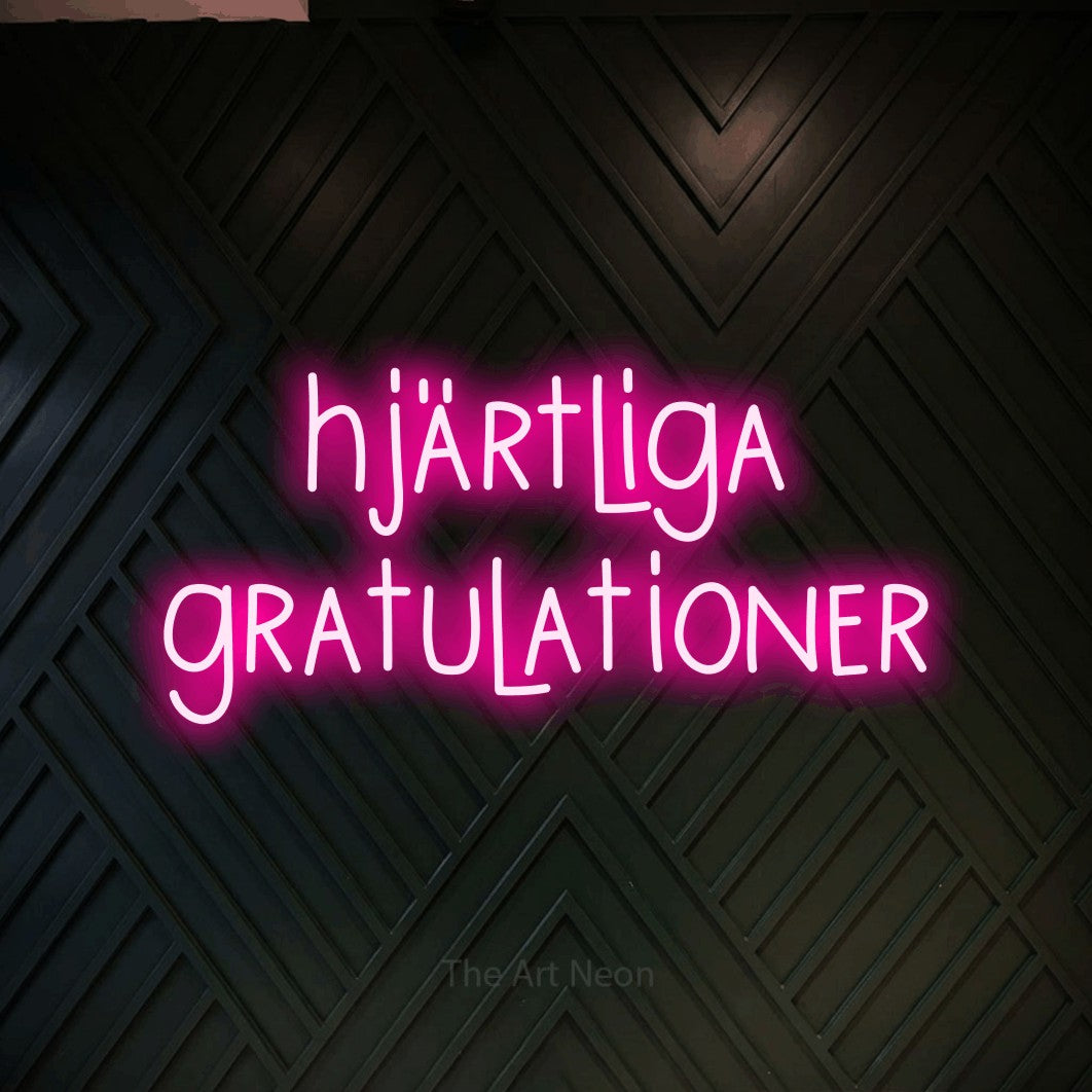 LED neon sign reading “hjärtliga gratulationer”, arranged in 2 lines.