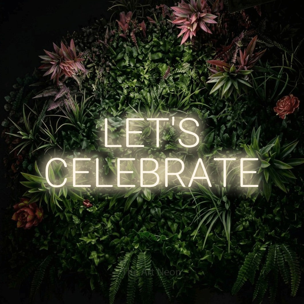 LED neon sign reading “LET'S CELEBRATE”, arranged in 2 lines.