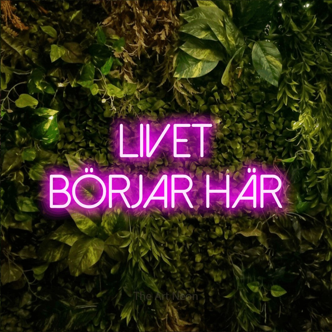 LED neon sign reading “LIVET BÖRJAR HÄR”, arranged in 2 lines.