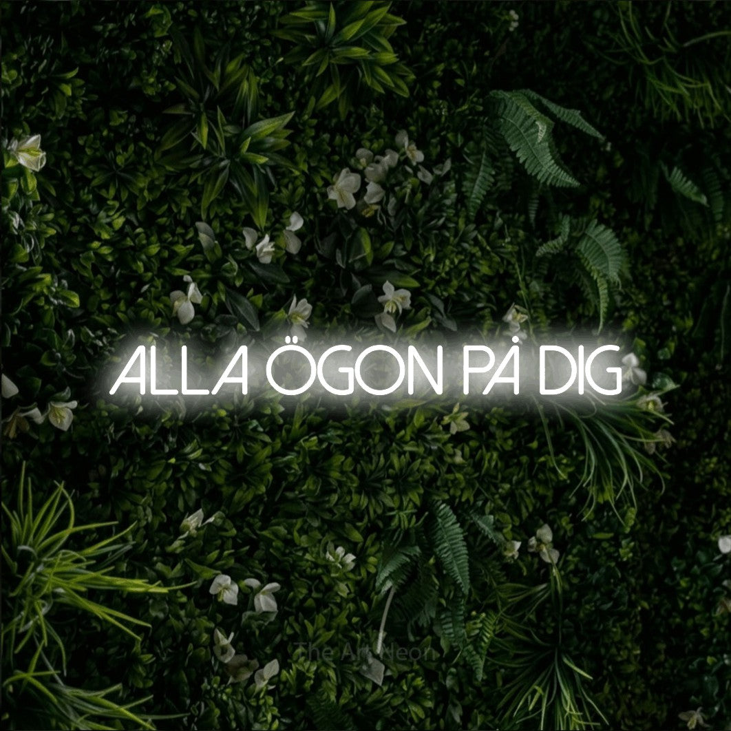 LED neon sign reading “alla ögon på dig”, arranged in a single line.