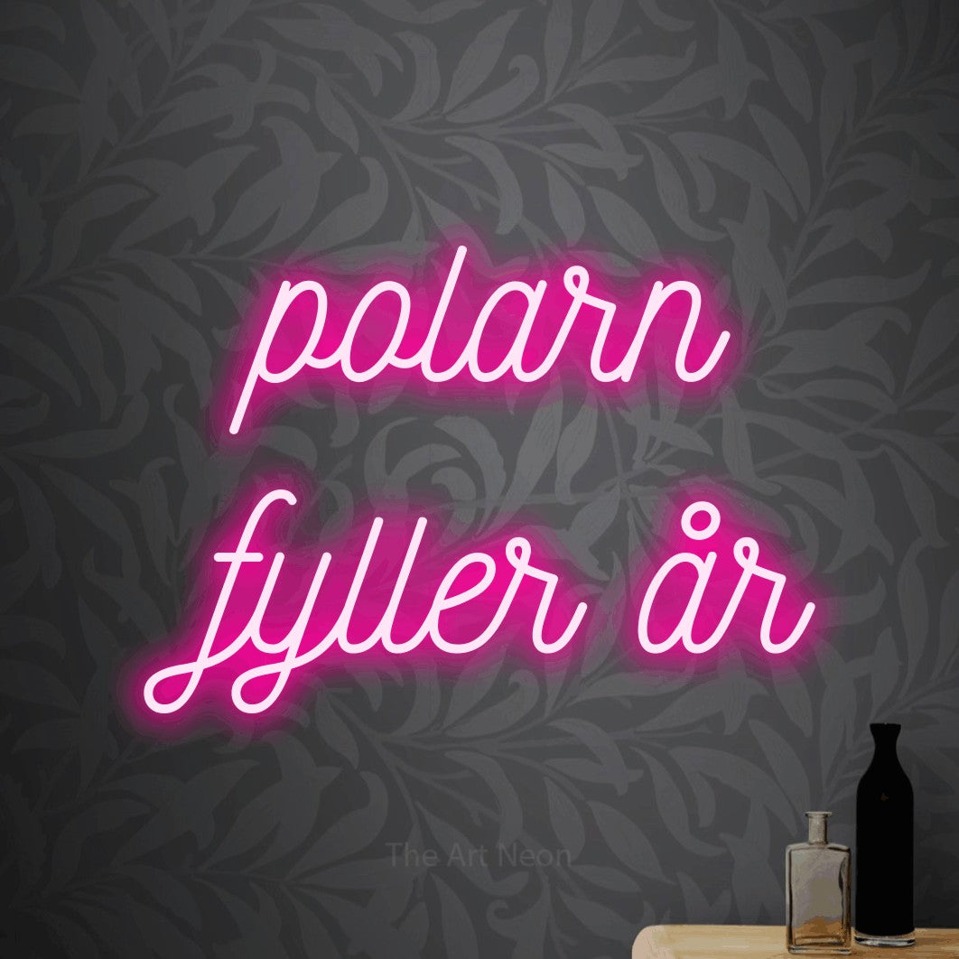 LED neon sign reading “polarn fyller år”, arranged in 2 lines.