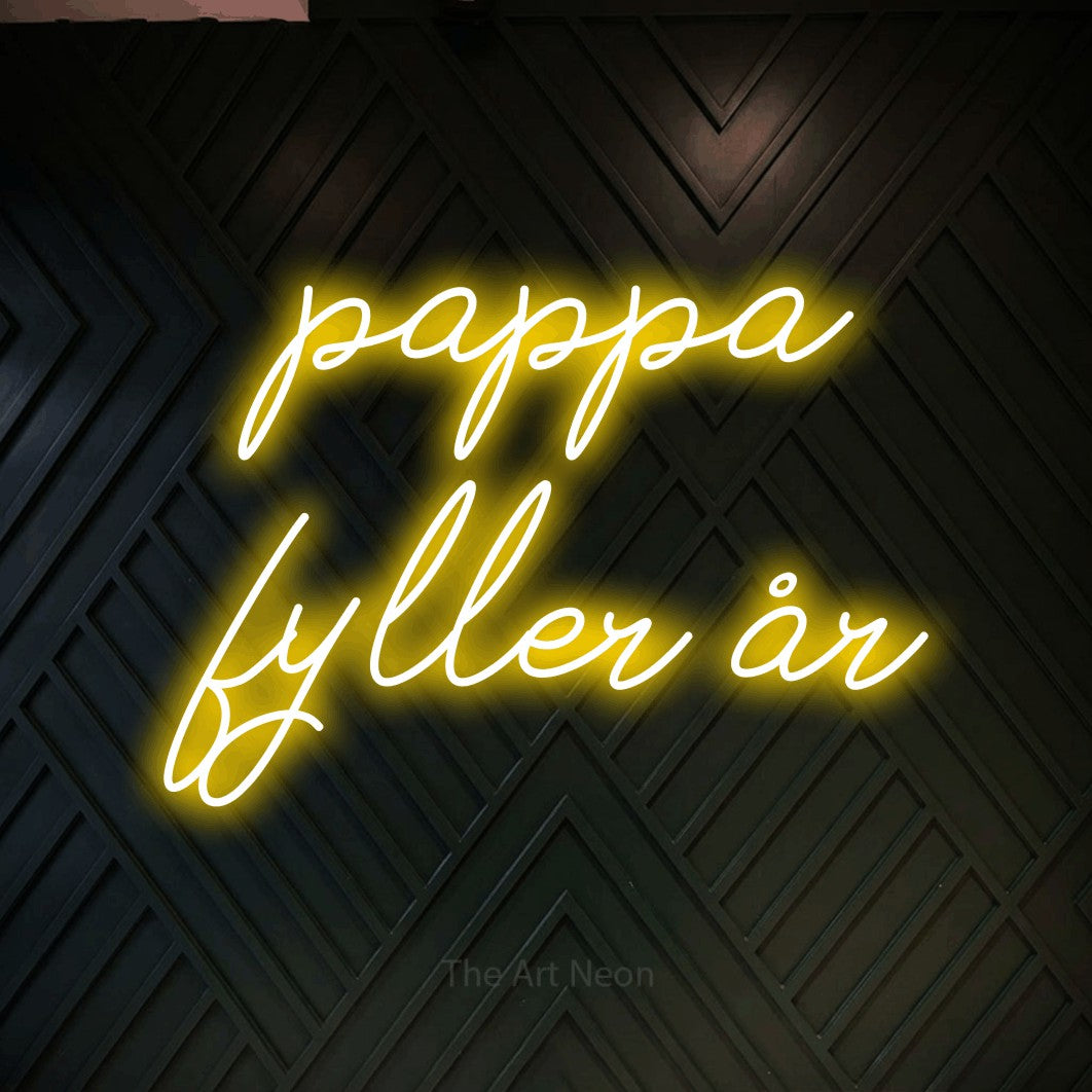 LED neon sign reading “pappa fyller år”, arranged in 2 lines.