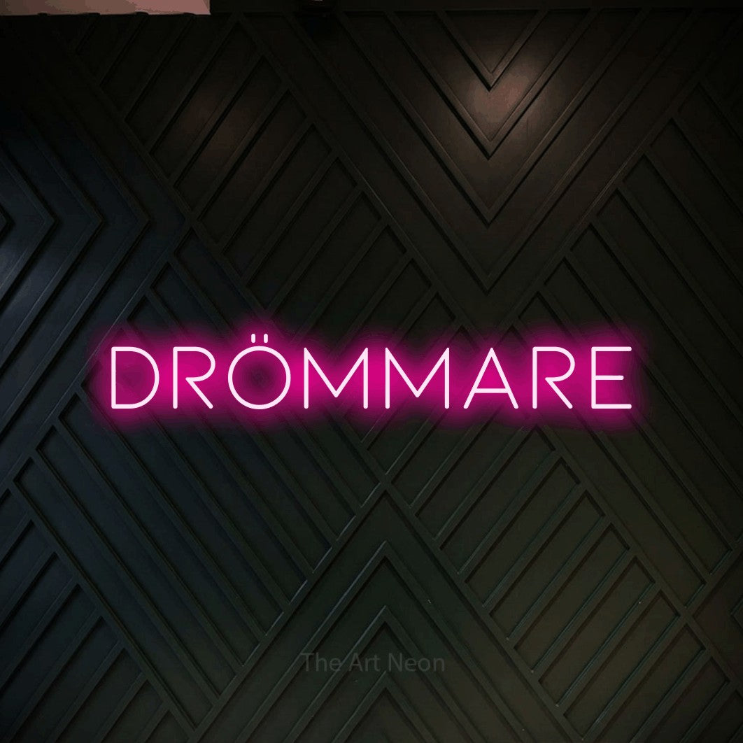 LED neon sign reading “DRÖMMARE”, arranged in a single line.