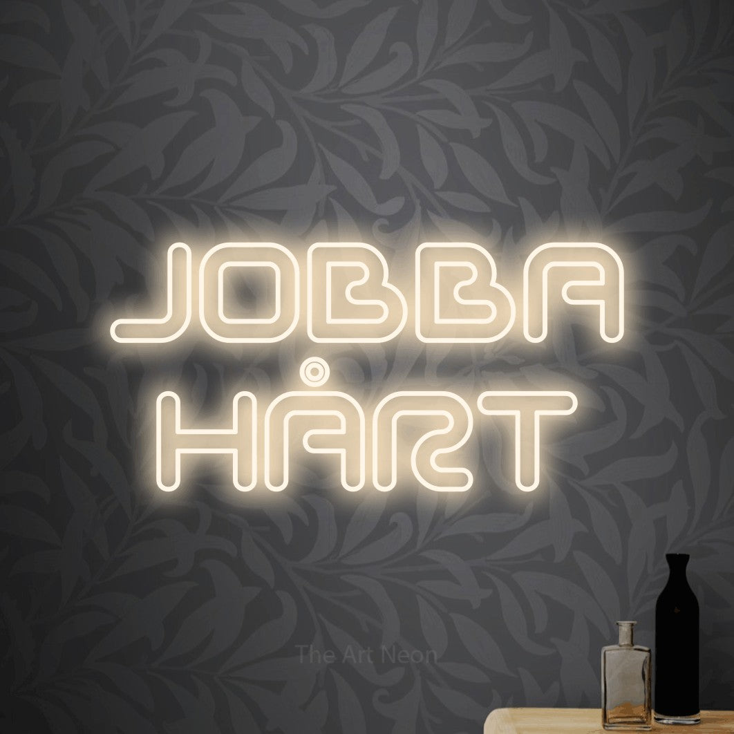 LED neon sign reading “JOBBA HÅRT”, arranged in 2 lines.