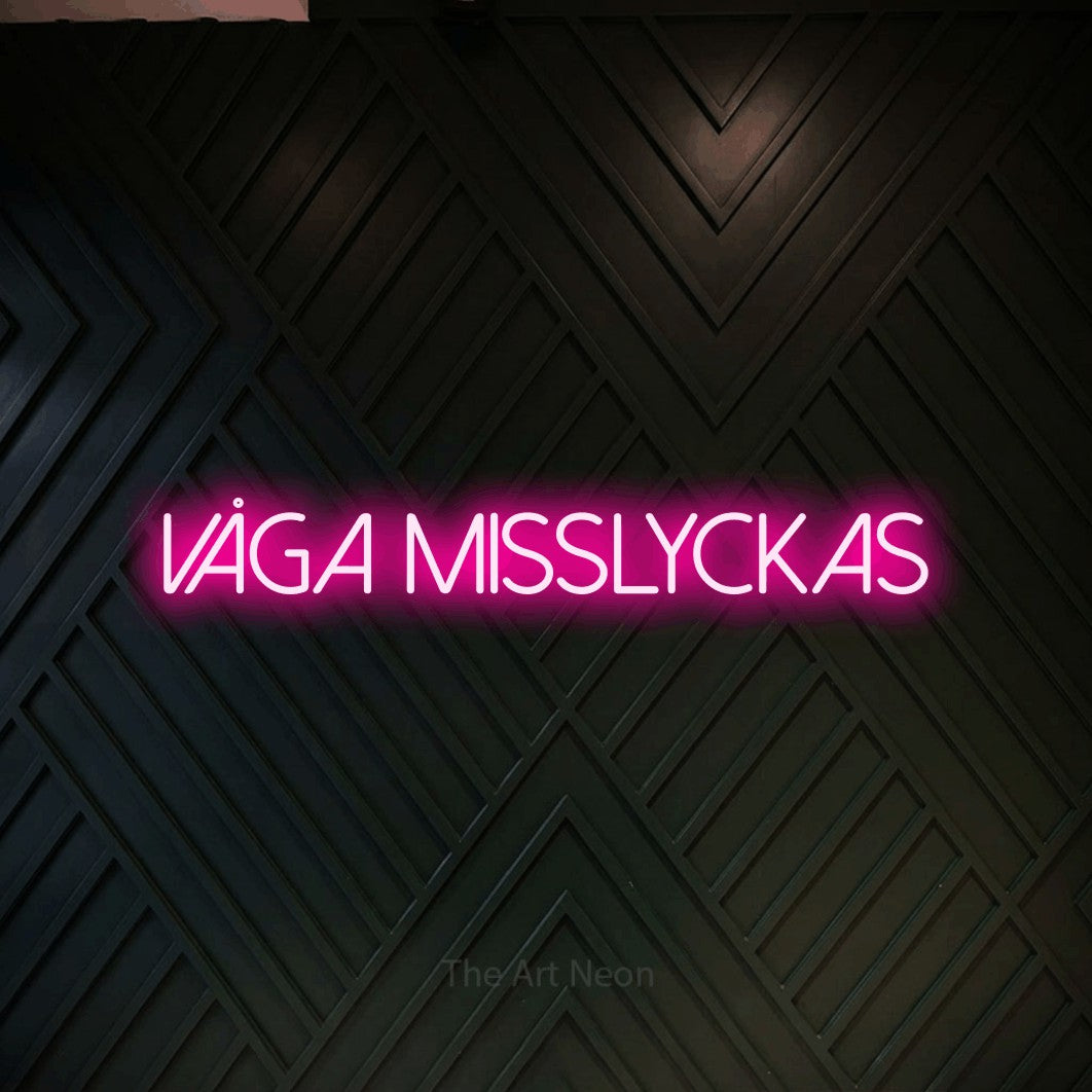 LED neon sign reading “VÅGA MISSLYCKAS”, arranged in a single line.