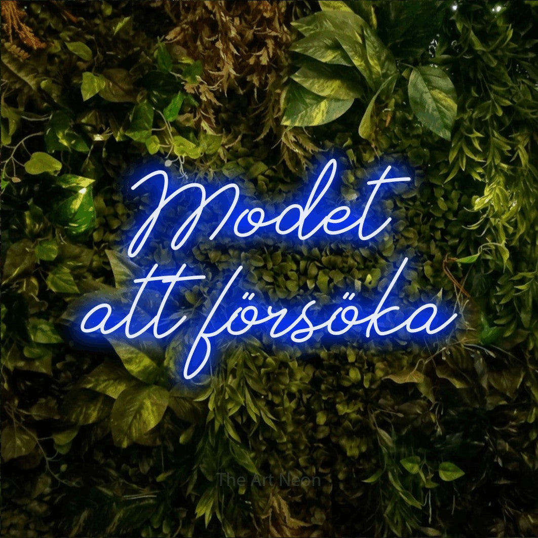 LED neon sign reading “Modet att försöka”, arranged in 2 lines.