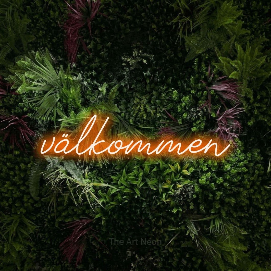 LED neon sign reading “välkommen”, arranged in a single line.