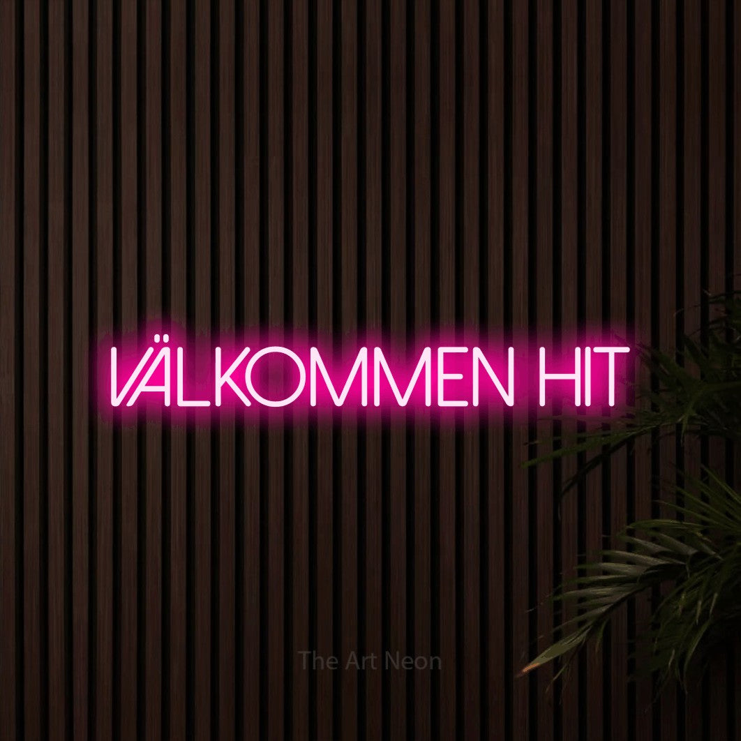 LED neon sign reading “Välkommen Hit”, arranged in a single line.