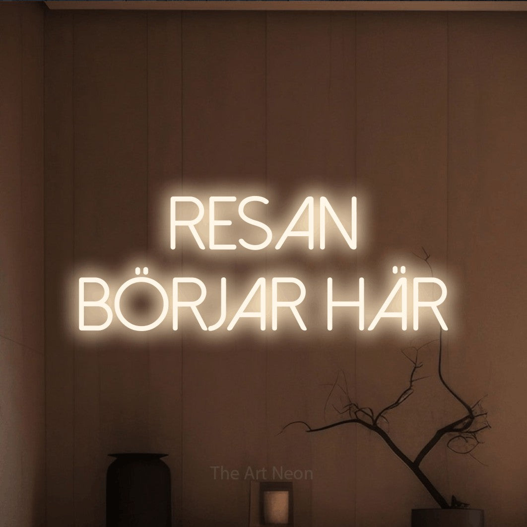 LED neon sign reading “resan börjar här”, arranged in 2 lines.