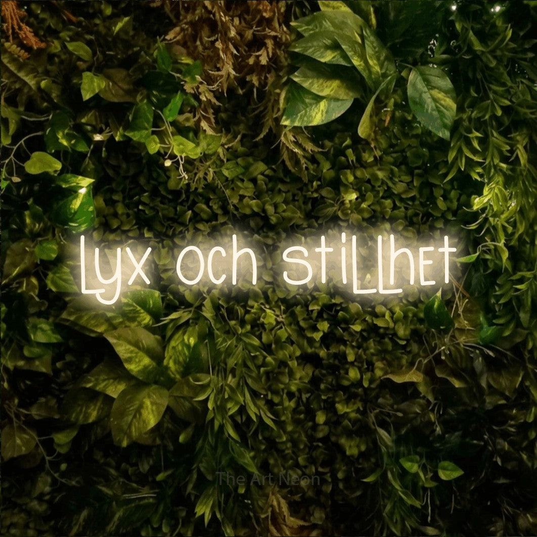 LED neon sign reading “lyx och stillhet”, arranged in a single line.