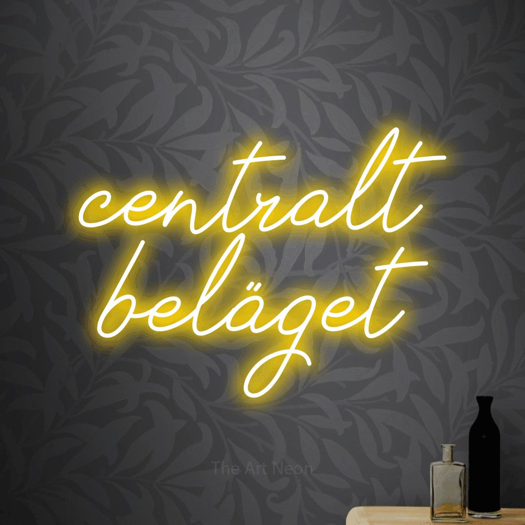 LED neon sign reading “centralt beläget”, arranged in 2 lines.