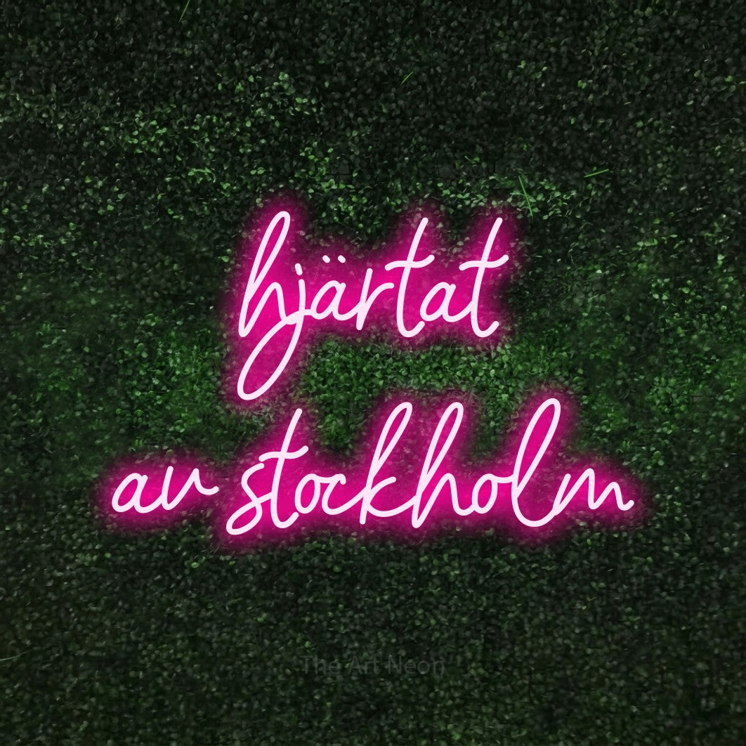 LED neon sign reading “hjärtat av stockholm”, arranged in 2 lines.