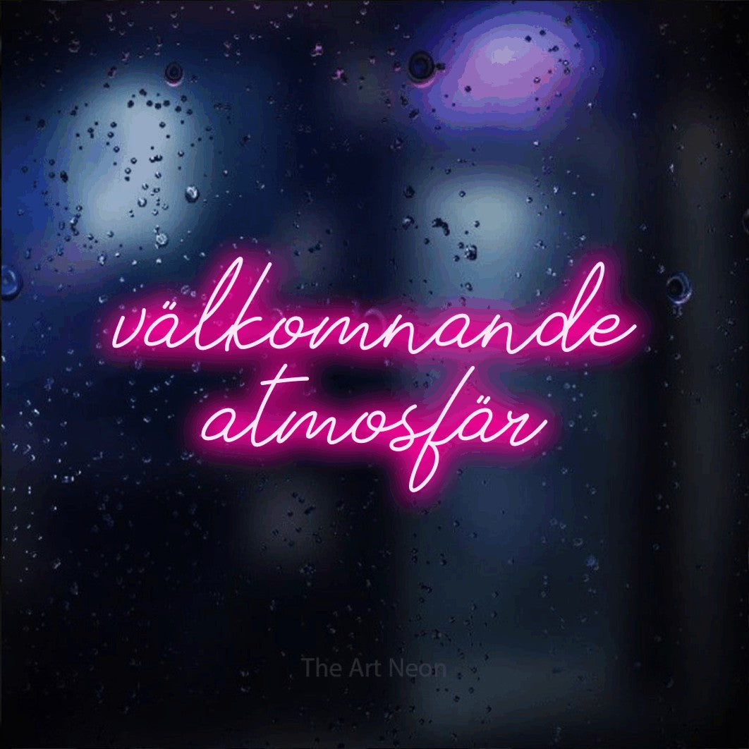 LED neon sign reading “välkomnande atmosfär”, arranged in 2 lines.