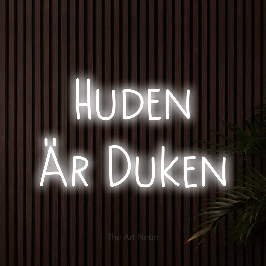 LED neon sign reading “Huden Är Duken”, arranged in 2 lines.