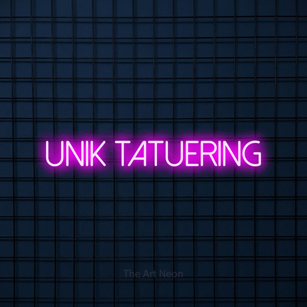 LED neon sign reading “unik TATUERING”, arranged in a single line.
