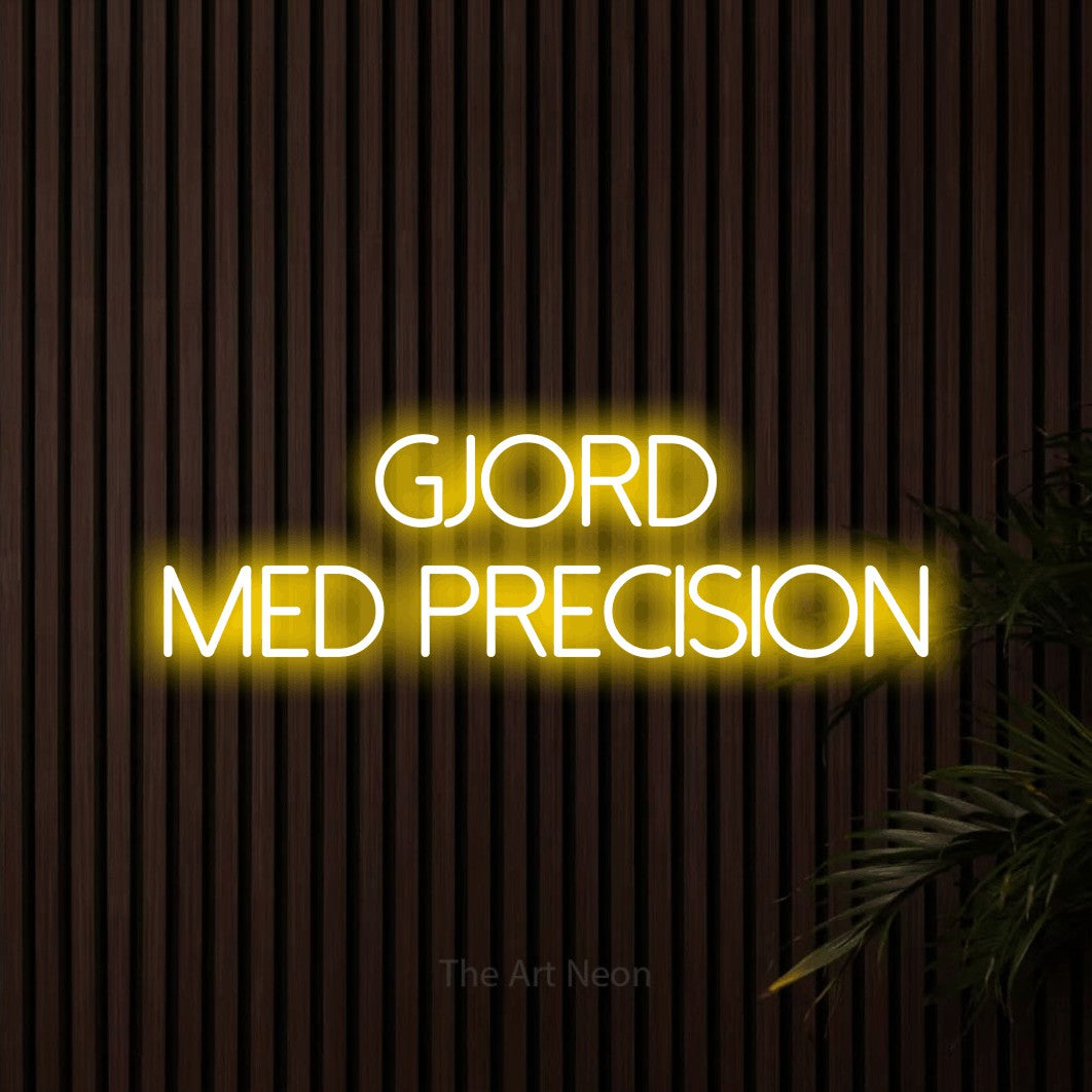 LED neon sign reading “gjord med precision”, arranged in 2 lines.