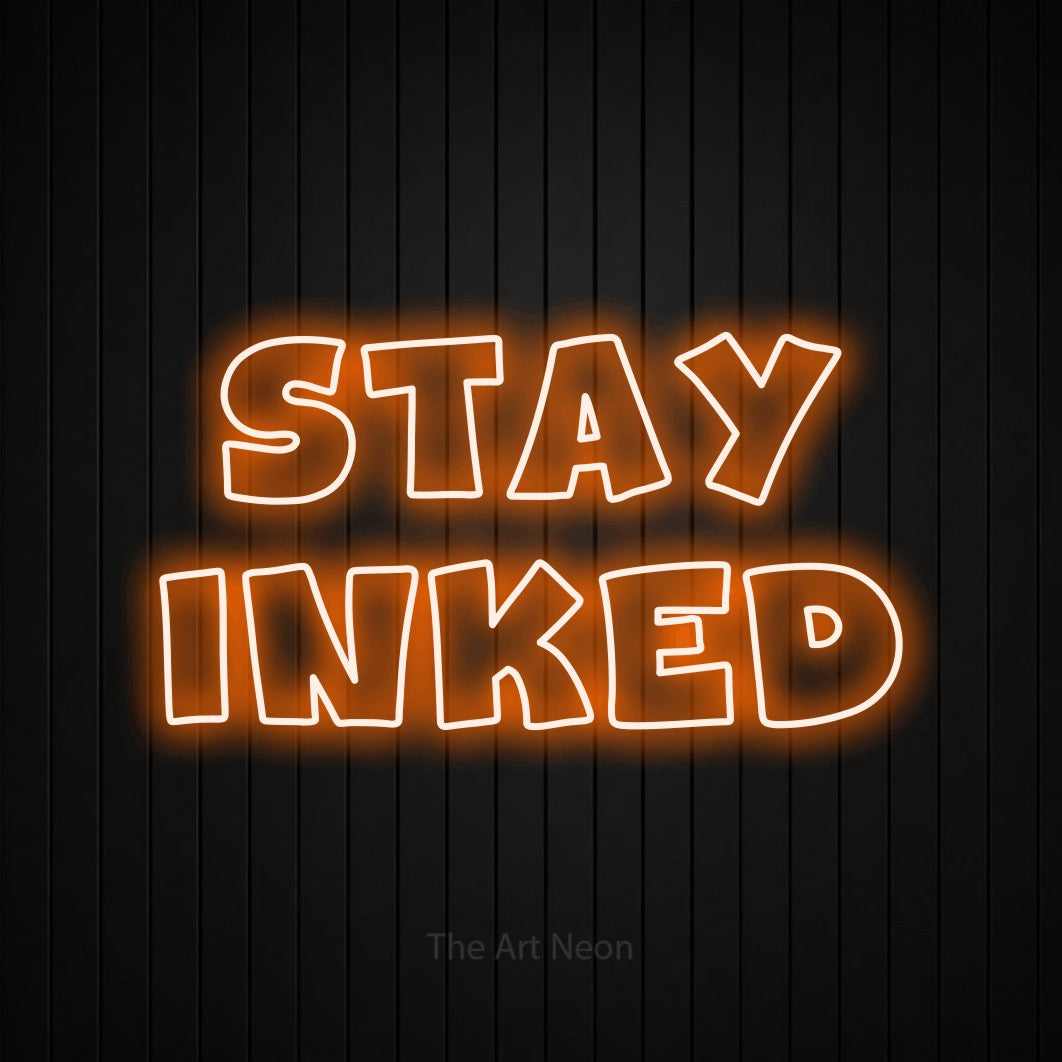 LED neon sign reading “Stay Inked”, arranged in 2 lines.