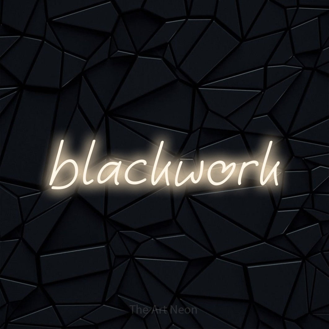 LED neon sign reading “blackwork”, arranged in a single line.
